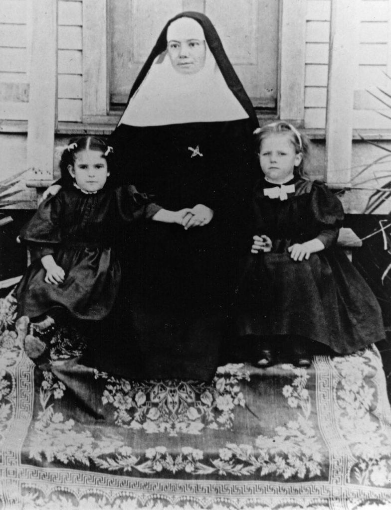 A nun from the Sisters of Charity Order, with two orphans in her charge. Courtesy of the Rosenberg Library, Galveston, Texas.
