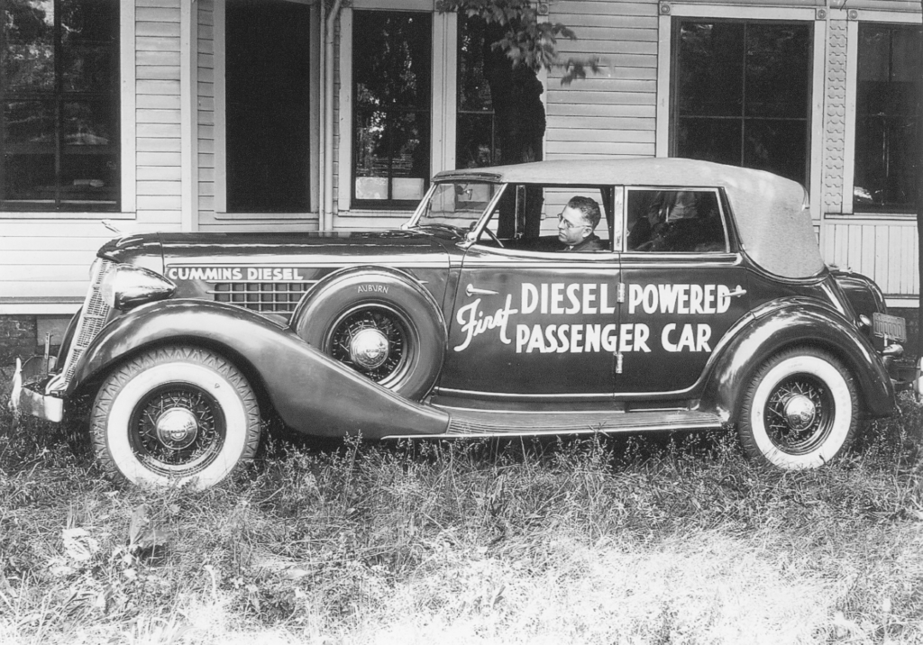 An image of Clessie Lyle Cummins in an early automobile.