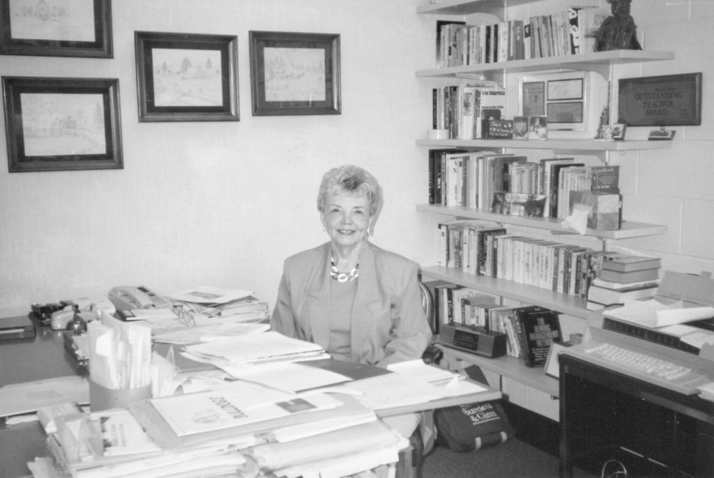 A photo of teacher Shirley Lyster at her classroom desk.