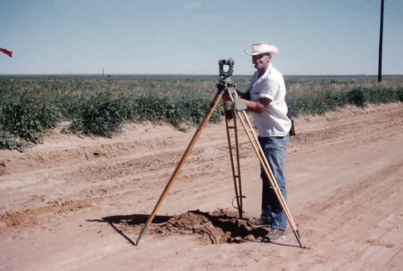 A photo of Bob D Henderson with a Wild T2 optical theodolite