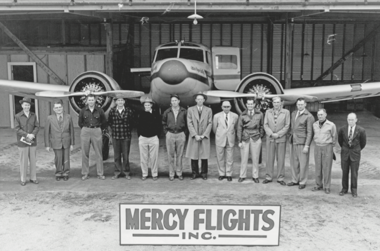 A photo of the community members who donated to Mercy Flights in front of a plane