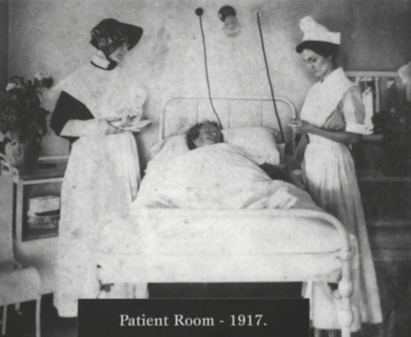 Two St. Francis nurses with a patient in 1917