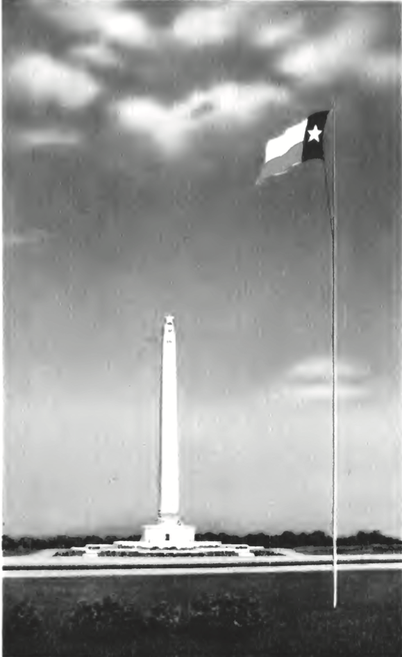 A postcard photo of the San Jacinto Monument in the background with the Texas flag in the foreground