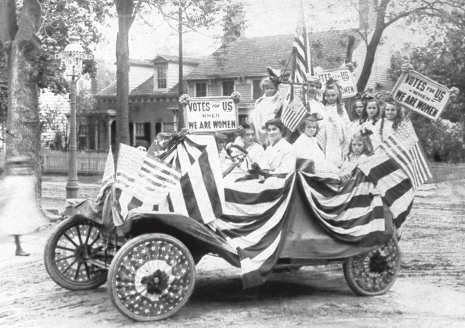 Suffragettes rallying in a car