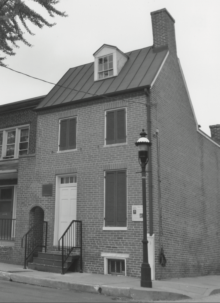 A black and white photo of the corner house where Poe lived in Baltimore.