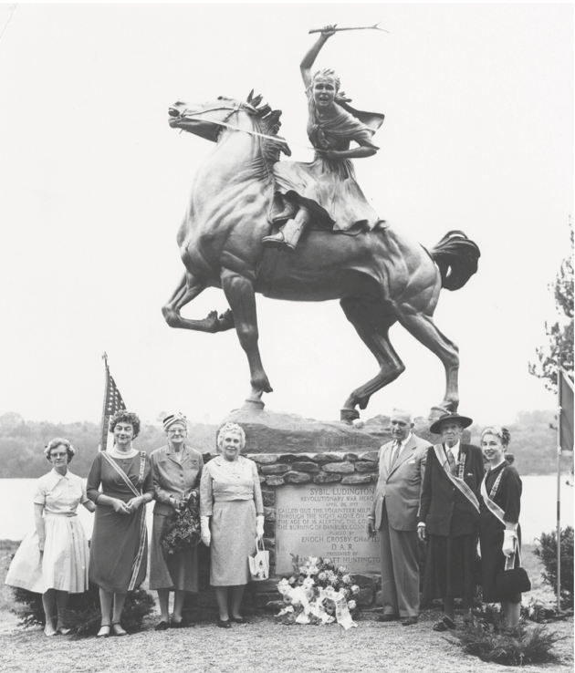 7 people standing in front of Sybil Luddington statue