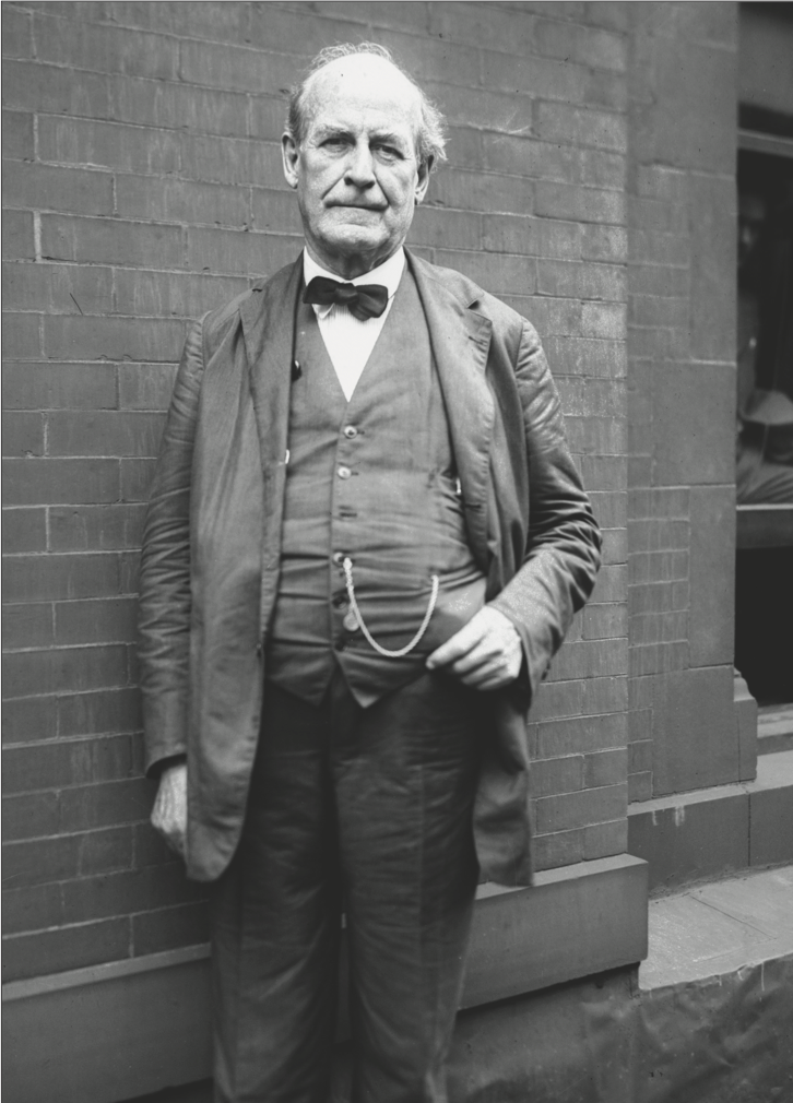 William Jennings Bryan standing up against a brick wall