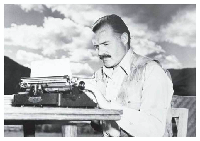 Ernest Hemingway typing on his typewriter out on a patio