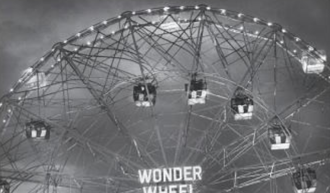 A black and white photo of the wonder wheel at night