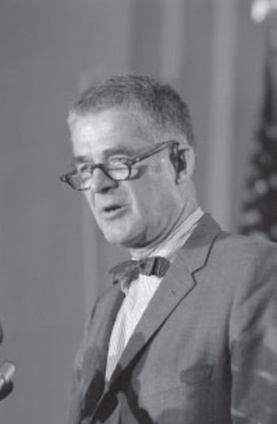 a photograph of Archibald Cox speaking at a podium
